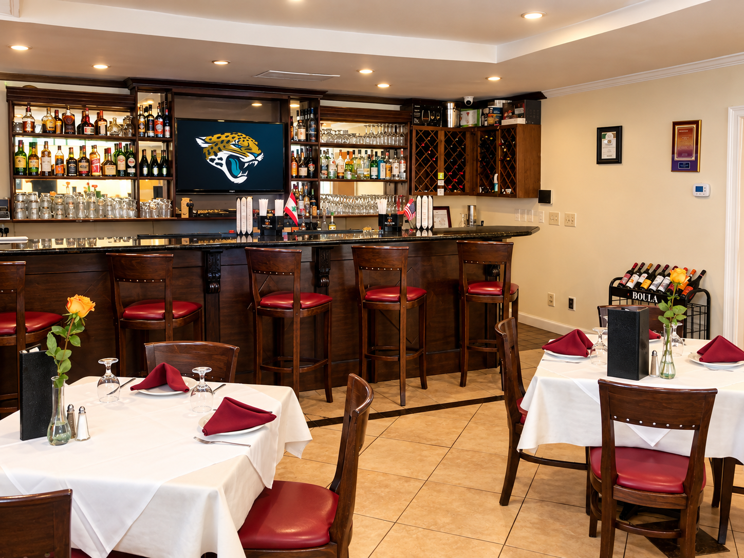 Mandaloun dining room and bar with warm lighting and red accents